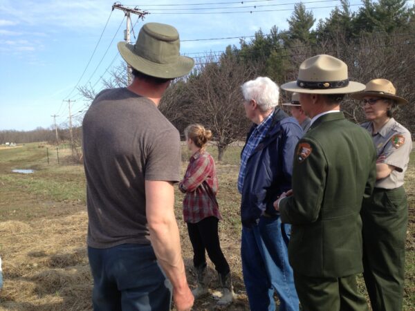 A field visit near a working farm landscape